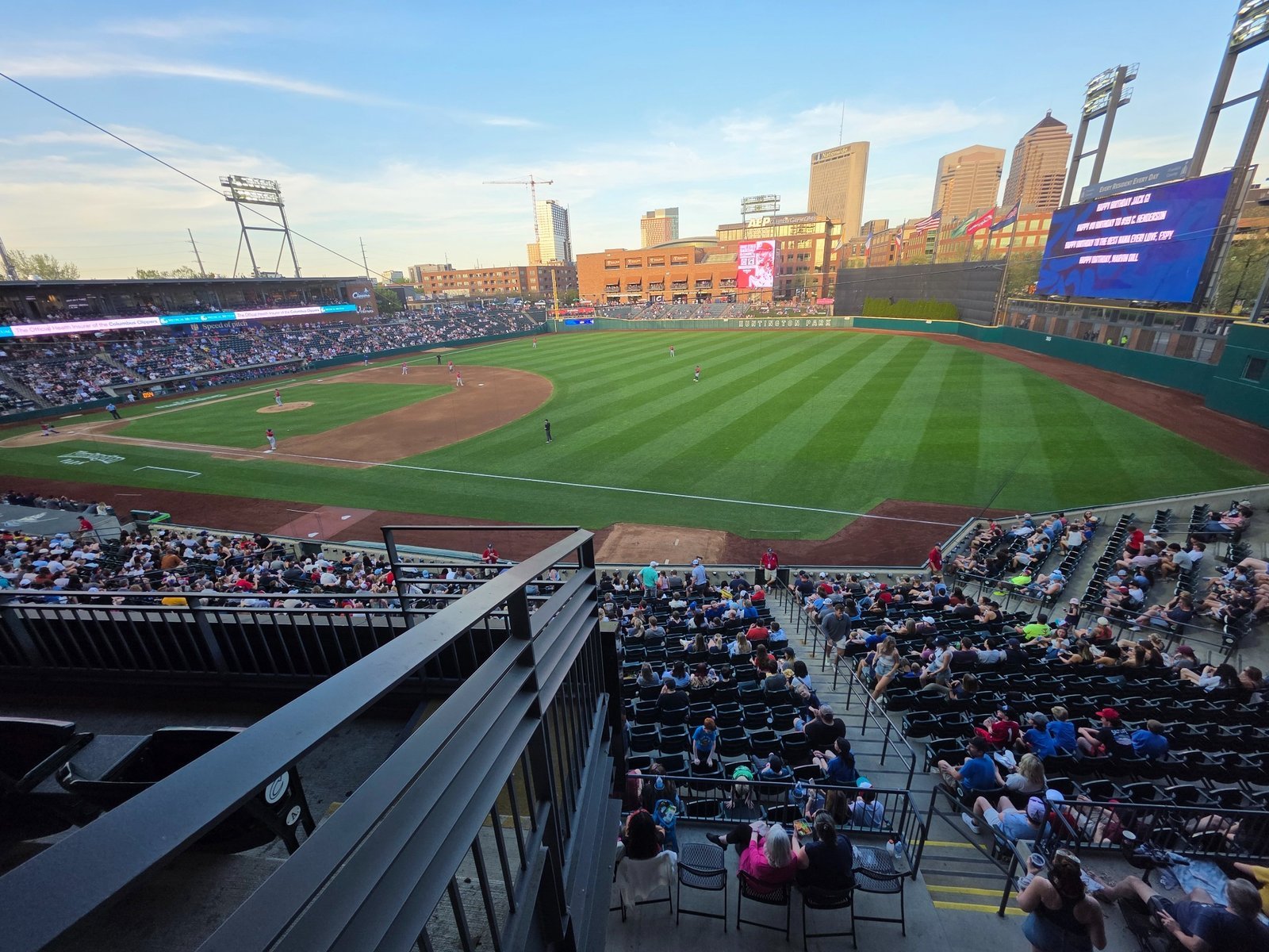 Baseball park and city skyline at sunset